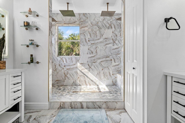 full bath with vanity, baseboards, marble finish floor, and a marble finish shower