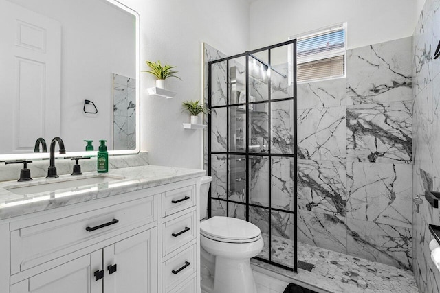 full bathroom with vanity, toilet, marble finish floor, and a marble finish shower