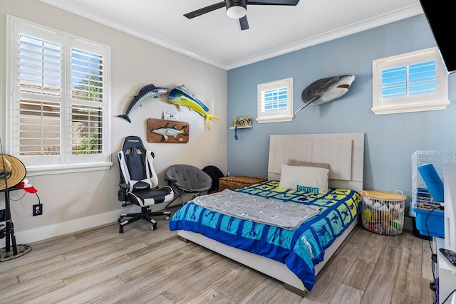 bedroom with baseboards, wood finished floors, a ceiling fan, and ornamental molding