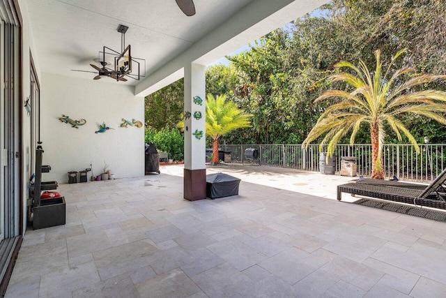 view of patio / terrace with a ceiling fan and fence