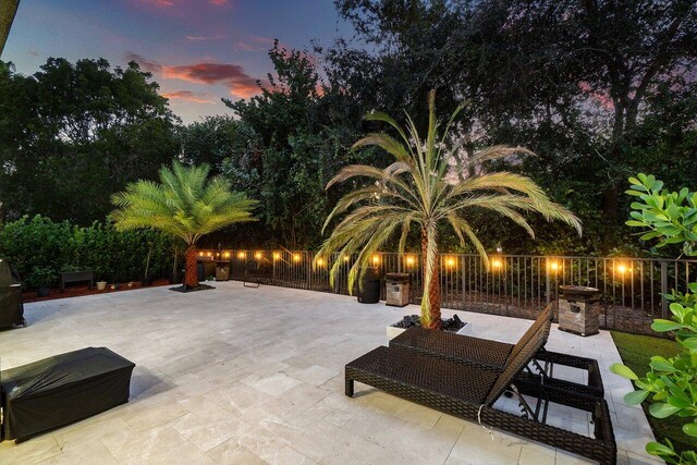 back of house with ceiling fan and a patio