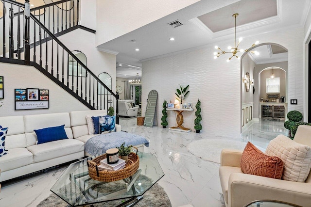 living room featuring ornamental molding, visible vents, marble finish floor, and a chandelier