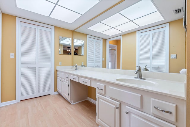 bathroom with vanity, an enclosed shower, and wood-type flooring