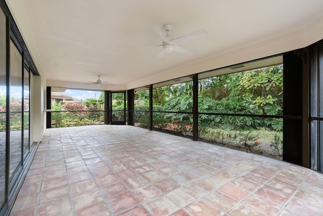 unfurnished sunroom featuring ceiling fan