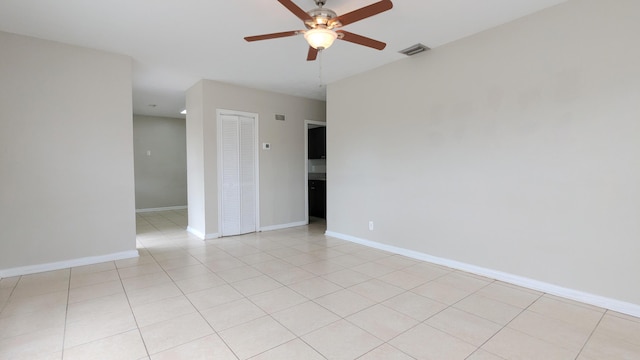 empty room featuring ceiling fan and light tile patterned floors