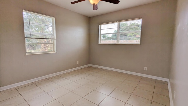 spare room with light tile patterned floors and ceiling fan