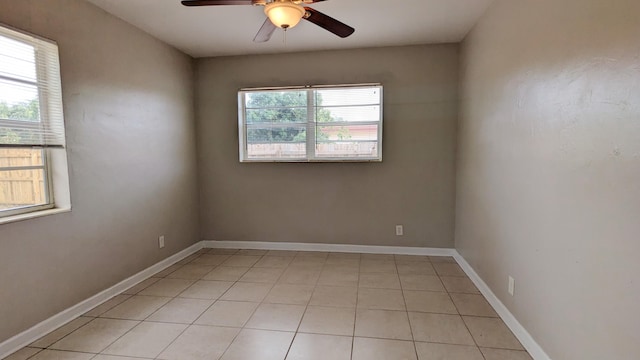 tiled empty room with ceiling fan and a healthy amount of sunlight