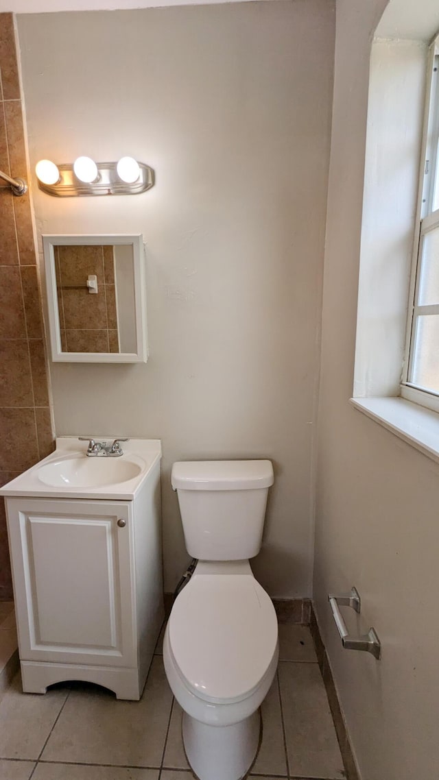 bathroom featuring tile patterned flooring, vanity, and toilet