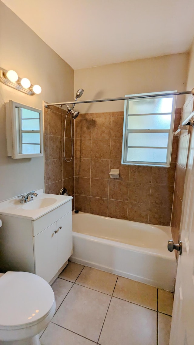 full bathroom featuring tile patterned floors, tiled shower / bath combo, a healthy amount of sunlight, and toilet