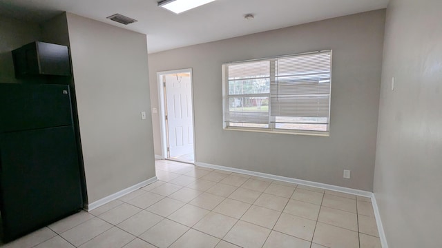 empty room featuring light tile patterned floors