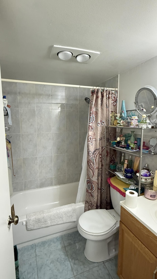 full bathroom featuring tile patterned flooring, shower / bath combo, toilet, and vanity