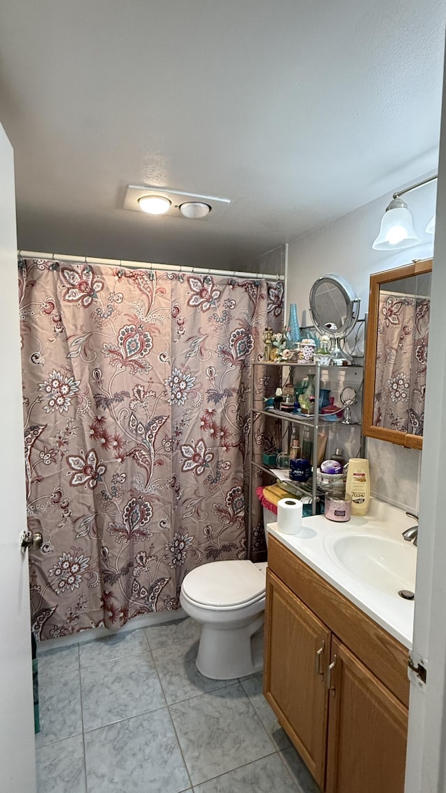 bathroom with tile patterned flooring, vanity, toilet, and a shower with shower curtain