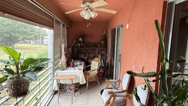 sunroom / solarium featuring ceiling fan