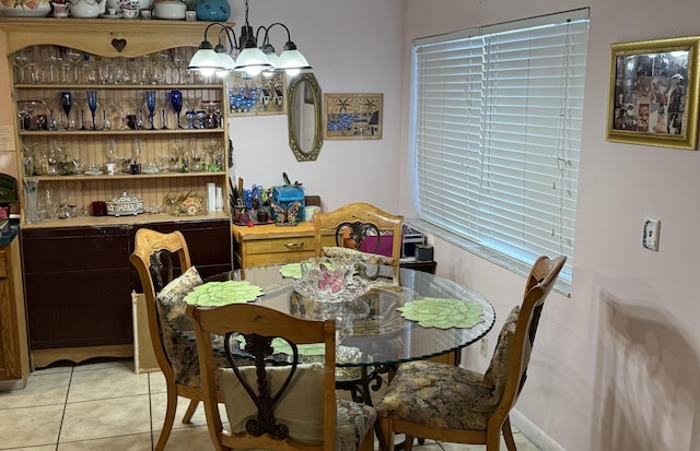 tiled dining space with a chandelier