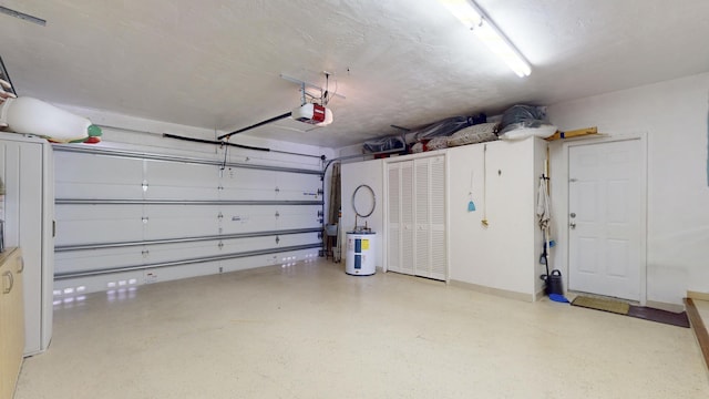 garage with electric water heater and a garage door opener