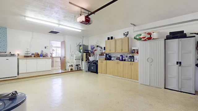 garage with washer / dryer and a garage door opener