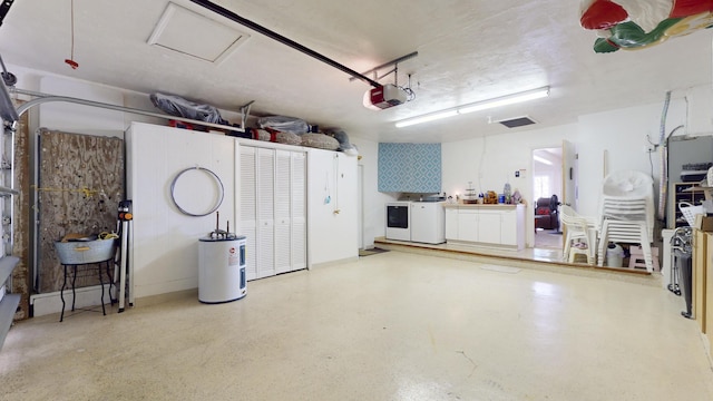 garage featuring washer and clothes dryer, a garage door opener, and water heater