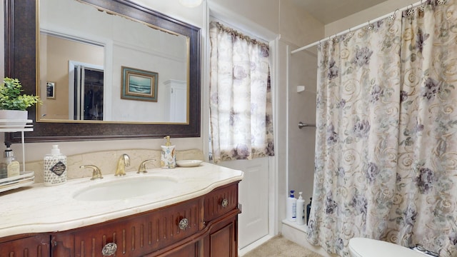 bathroom with vanity, curtained shower, and toilet