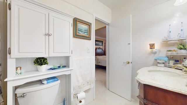 bathroom featuring tile patterned flooring, vanity, and toilet