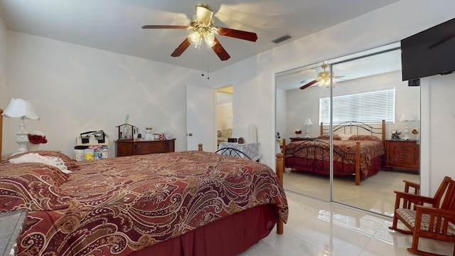 bedroom with a closet, ceiling fan, and light tile patterned flooring