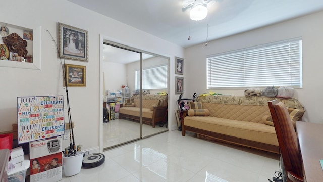 sitting room with ceiling fan and light tile patterned floors