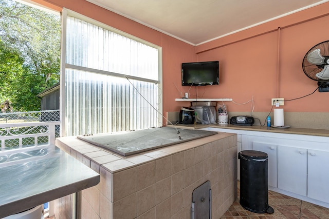 kitchen with tile countertops and white cabinets