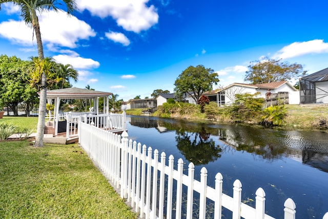 view of dock featuring a gazebo, a yard, and a water view