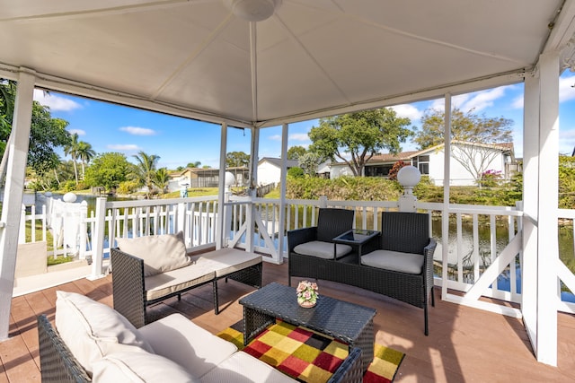 sunroom / solarium with a water view and a wealth of natural light