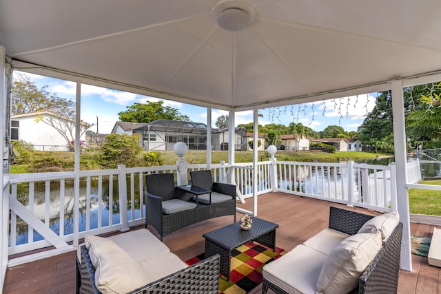 sunroom / solarium with plenty of natural light and a water view