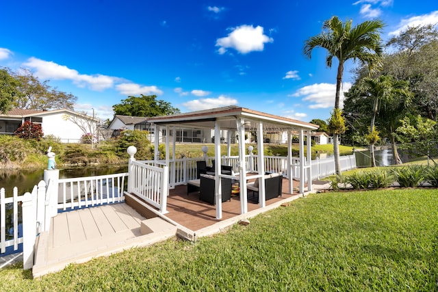 deck with a lawn, an outdoor living space, and a water view