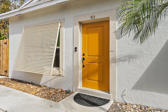 513 E Whitney Dr, Jupiter, FL 33458 - view of exterior entry with stucco siding