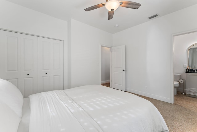 bedroom with ceiling fan, ensuite bath, and a closet