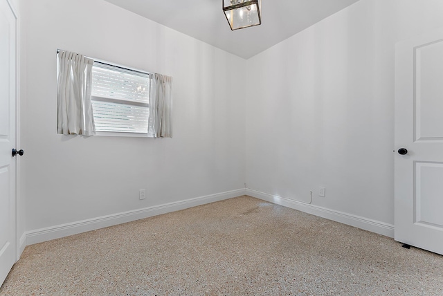 513 E Whitney Dr, Jupiter, FL 33458 - spare room featuring speckle patterned floor and baseboards