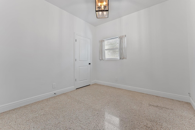 513 E Whitney Dr, Jupiter, FL 33458 - empty room featuring speckled floor and baseboards