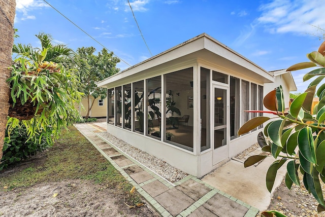 view of side of property with a sunroom