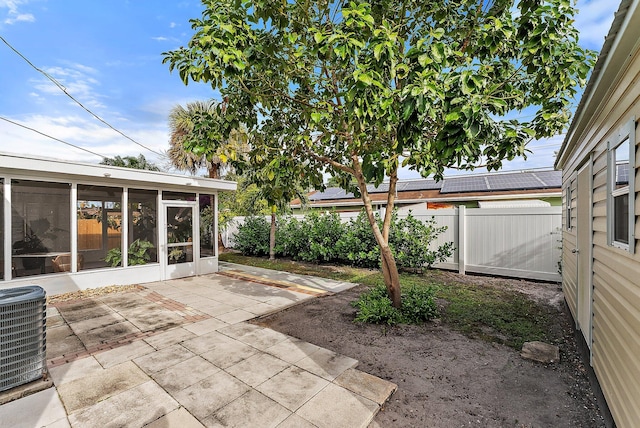 view of patio / terrace with a sunroom and central air condition unit