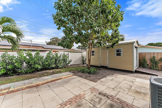 view of patio / terrace with a storage shed and central air condition unit