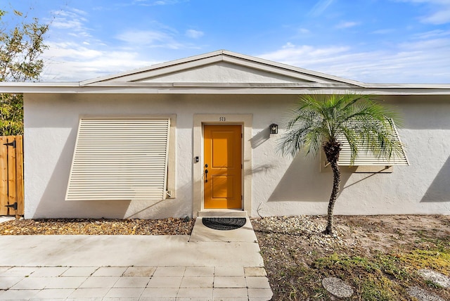 513 E Whitney Dr, Jupiter, FL 33458 - doorway to property with stucco siding