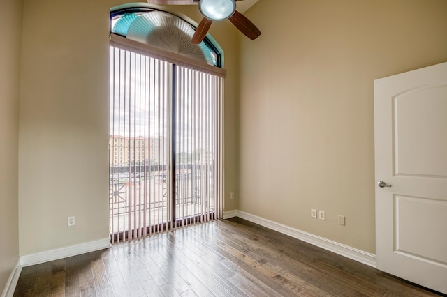 spare room featuring ceiling fan, plenty of natural light, and wood finished floors