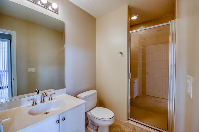 full bathroom featuring toilet, a shower stall, tile patterned flooring, vanity, and a textured ceiling