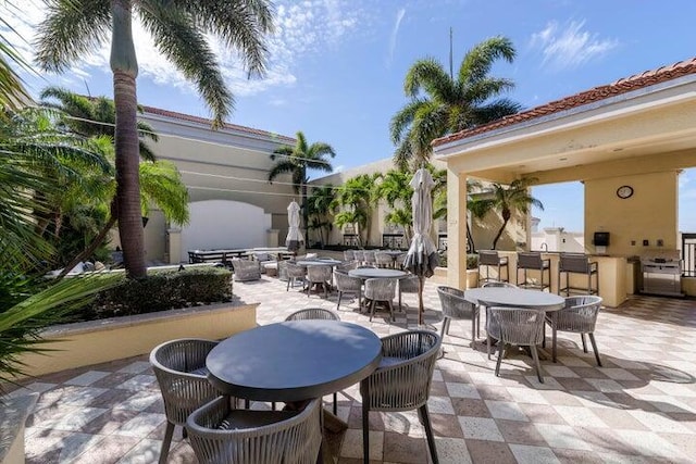 view of patio / terrace with outdoor dining space and an outdoor kitchen