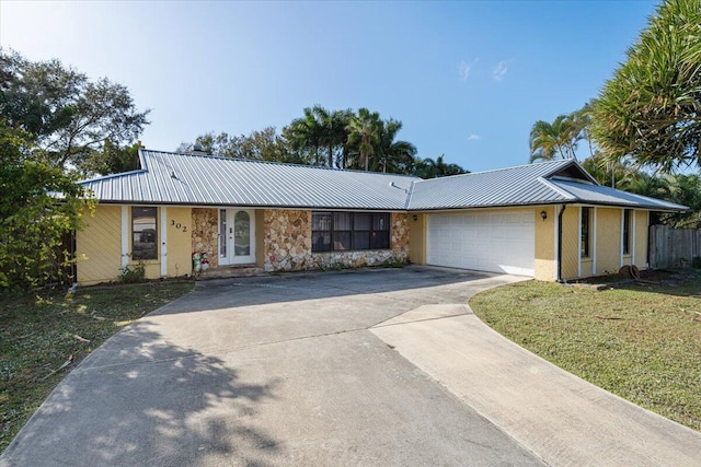 single story home featuring a garage and a front yard