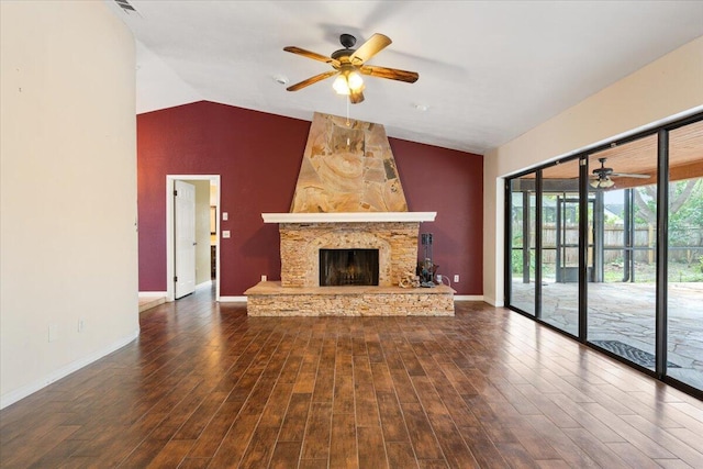 unfurnished living room featuring vaulted ceiling, dark hardwood / wood-style floors, ceiling fan, and a fireplace