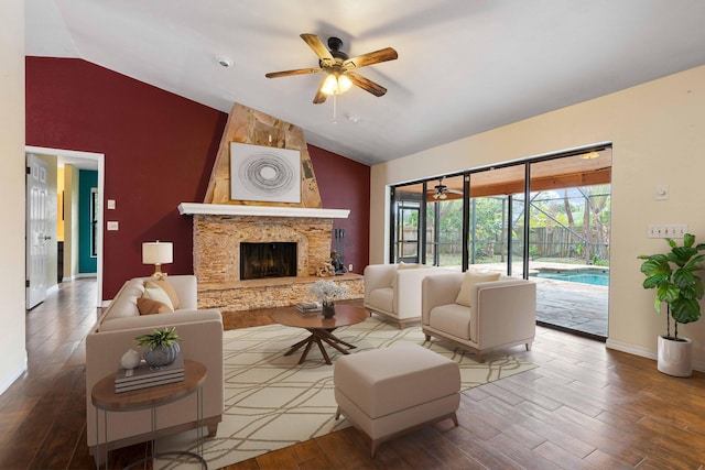 living room with ceiling fan, lofted ceiling, a fireplace, and wood-type flooring