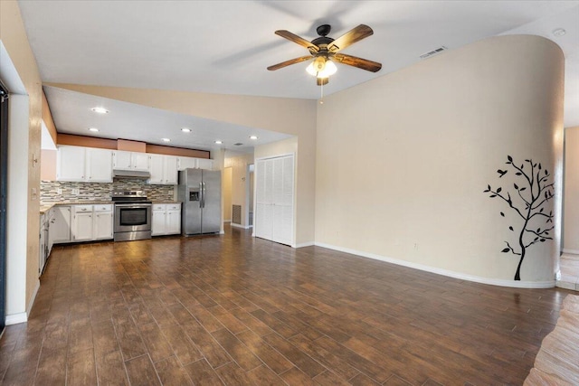 kitchen with lofted ceiling, white cabinetry, stainless steel appliances, dark hardwood / wood-style flooring, and decorative backsplash