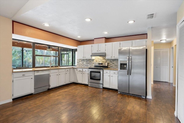 kitchen with tasteful backsplash, stainless steel appliances, and white cabinets