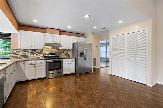 kitchen with tasteful backsplash, dark hardwood / wood-style flooring, white cabinets, and appliances with stainless steel finishes