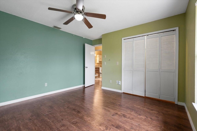 unfurnished bedroom featuring ceiling fan, dark hardwood / wood-style flooring, and a closet