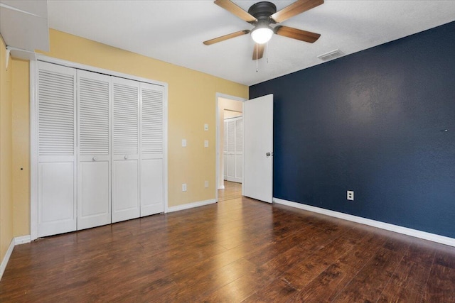 unfurnished bedroom featuring dark hardwood / wood-style flooring and ceiling fan