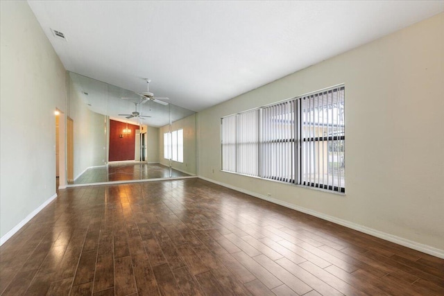 spare room with vaulted ceiling, ceiling fan, and dark hardwood / wood-style flooring